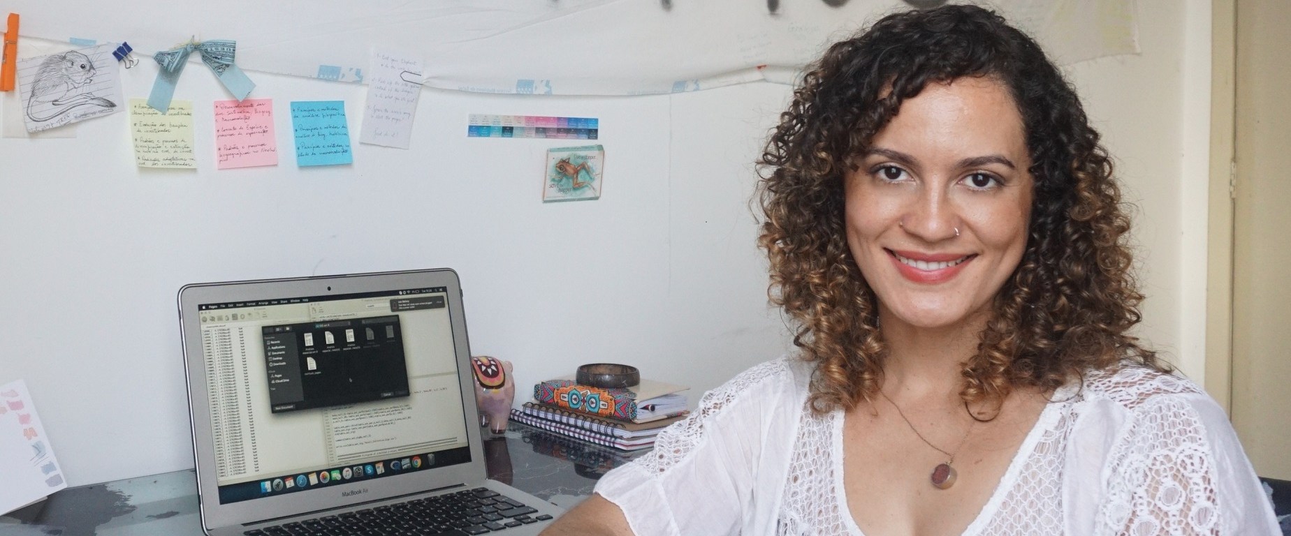 Talita Amado, sitting at her desk.