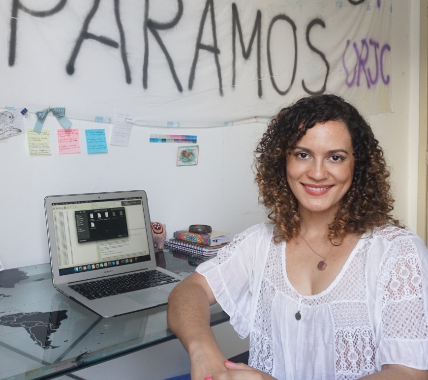 Talita Amado, sitting at her desk.