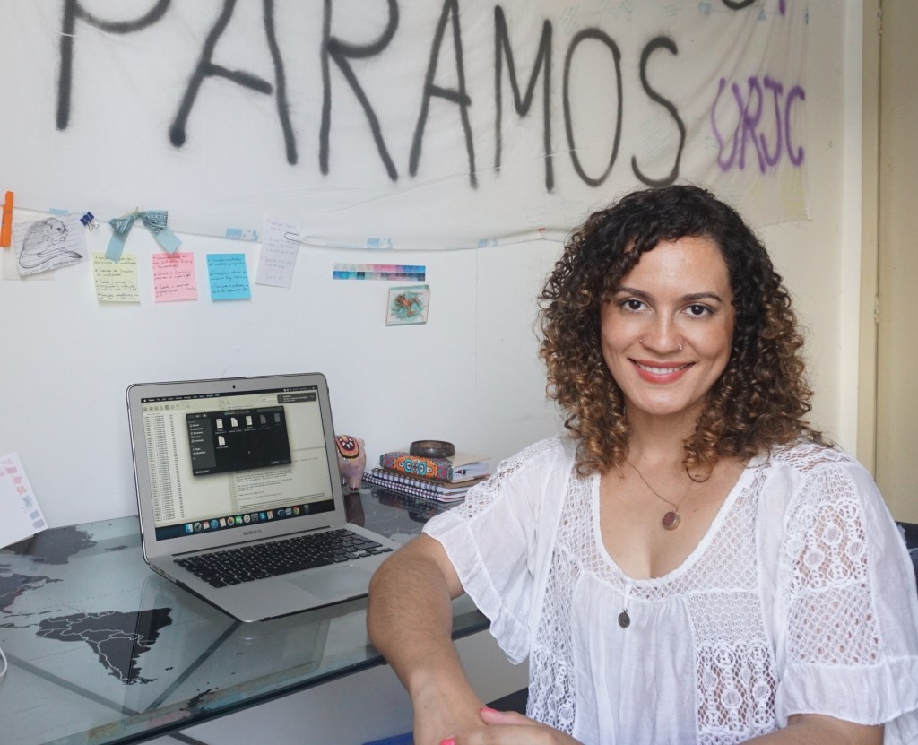 Talita Amado, sitting at her desk.