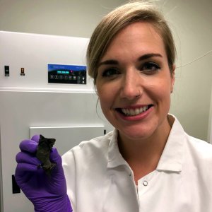 Anna Doty holding a small bat