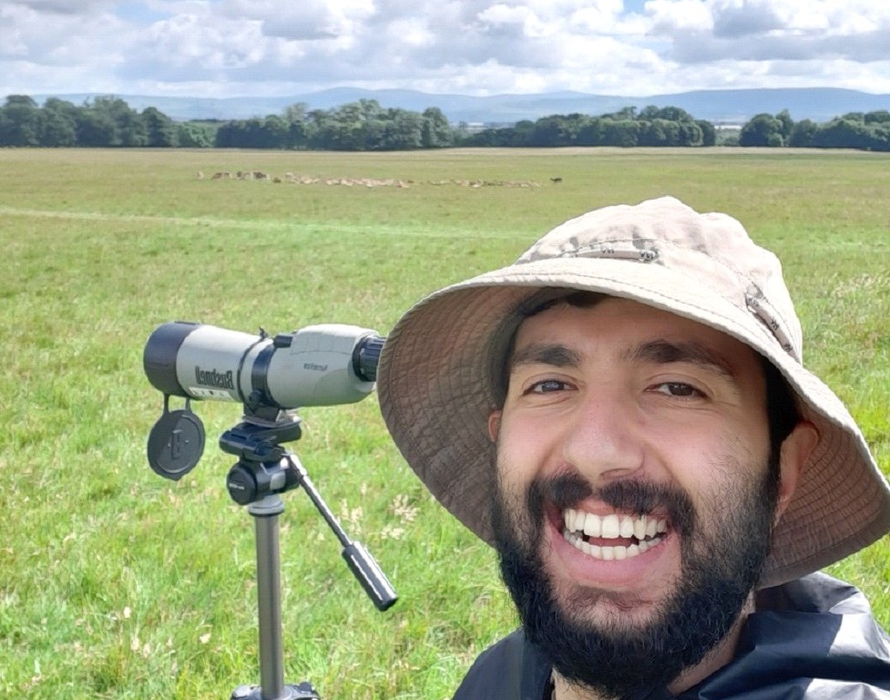 Bawan Amin in the field with a telescope tracked on fallow deer