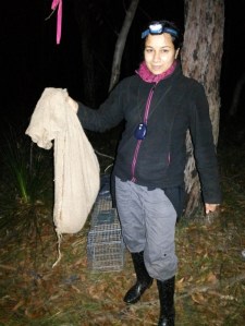Anushika holding a possum in a hessian bag during her field work in Ku-ring-gai Chase National Park
